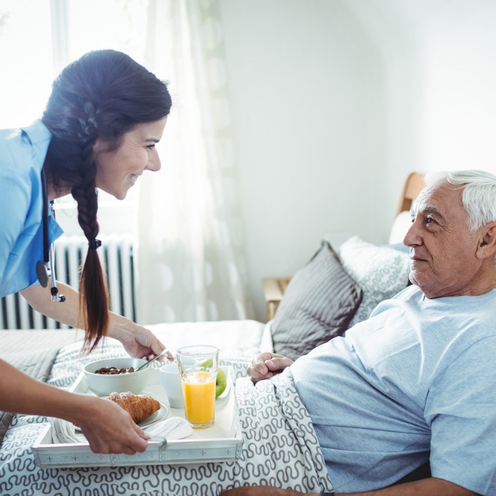 nurse-serving-breakfast-to-senior-man.jpg